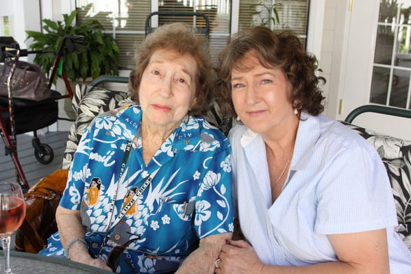 Two women smiling together in a cozy setting