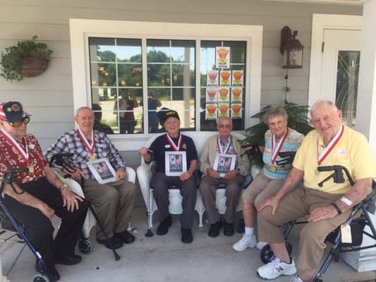 Residents celebrating with medals outdoors