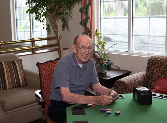 Resident engaging in a card game in a common area