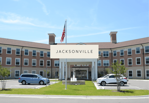 Front entrance of a senior living facility with cars