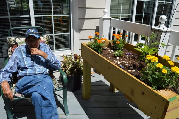 Resident gardening on a sunny patio