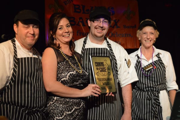 Staff celebrating with an award at an event