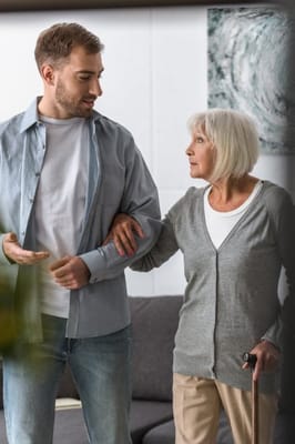 A caregiver assisting a resident inside a facility