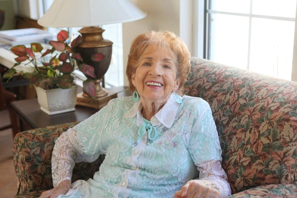 Smiling resident sitting in a cozy living room