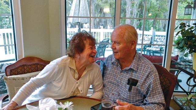Two residents enjoying a moment together in a dining area