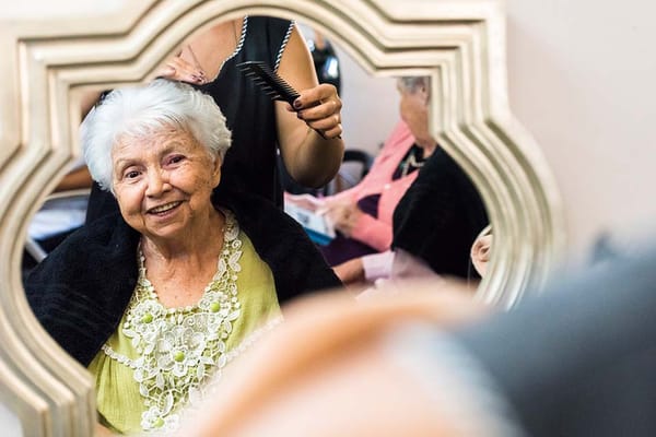 Resident getting a haircut in a salon setting