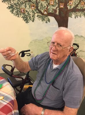 Resident enjoying dessert in a decorated dining area