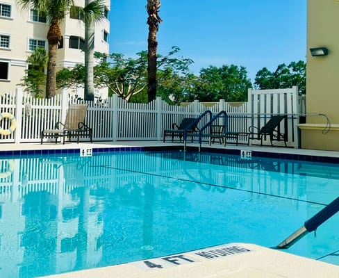 Clear view of an outdoor pool area with lounge chairs