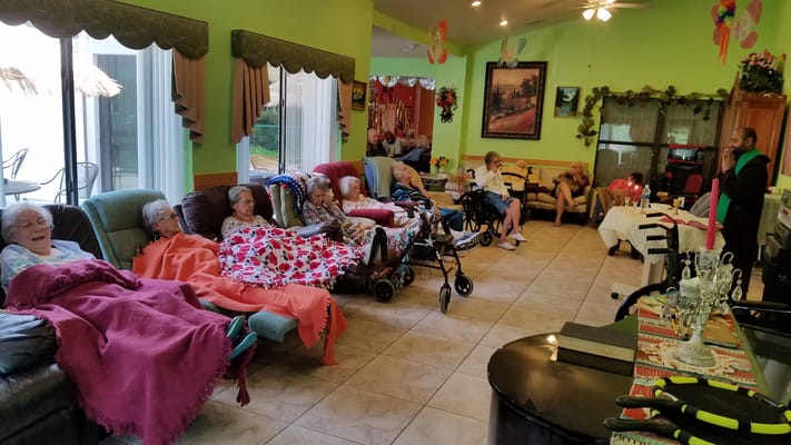 Residents relaxing in a common area with staff