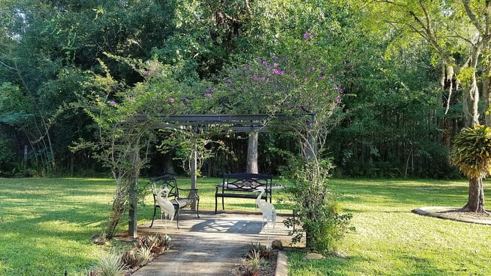 Outdoor seating area with gazebo and greenery