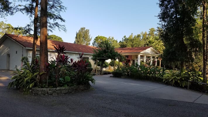 Exterior view of East Lake Manor with landscaped entrance