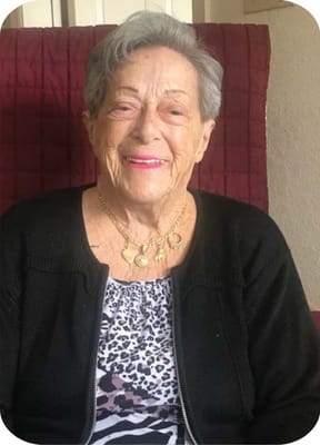 Resident smiling in a cozy seating area
