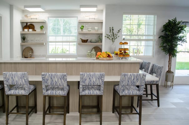 Bright dining area with fruit display and seating