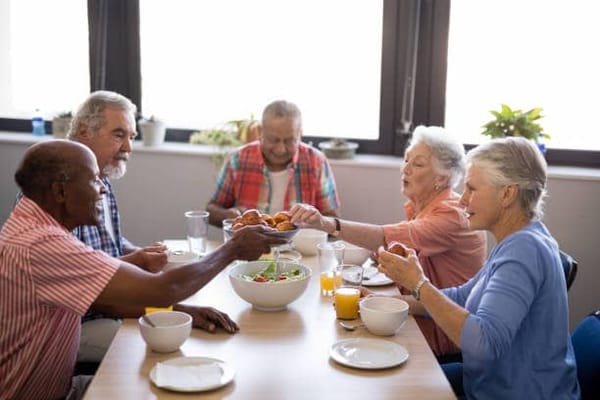 Residents enjoying a meal together in a dining area