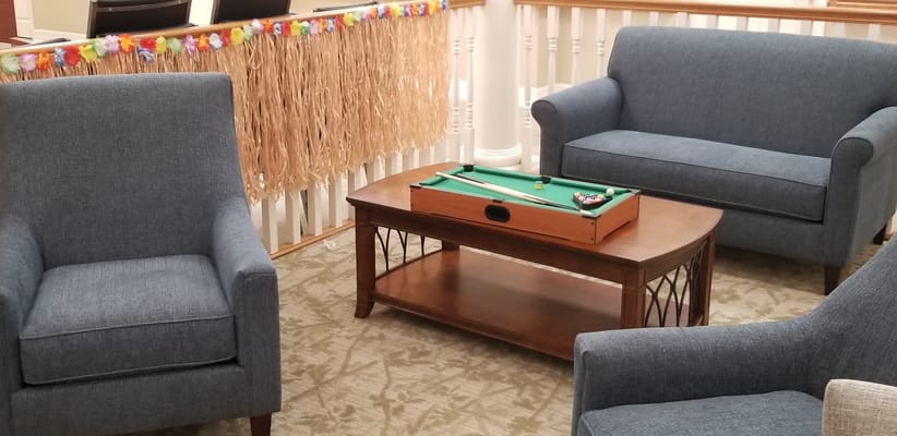 Seating area with a small pool table and decorative garland