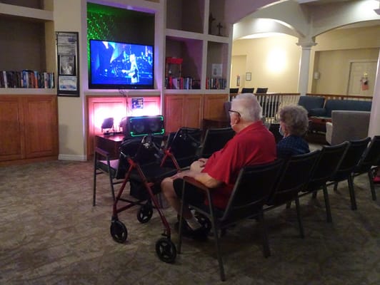 Residents enjoying a movie in the common area