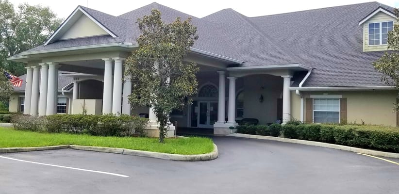Exterior view of a senior living facility with landscaping