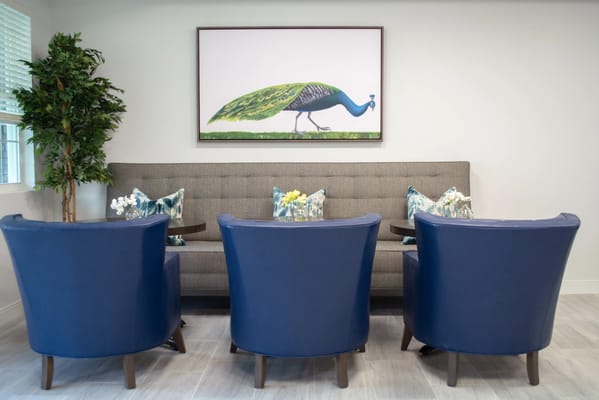 Common area with peacock artwork and seating
