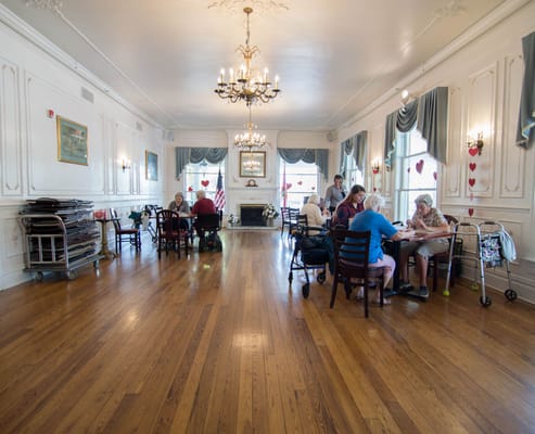 Residents engaged in an activity in a spacious common area