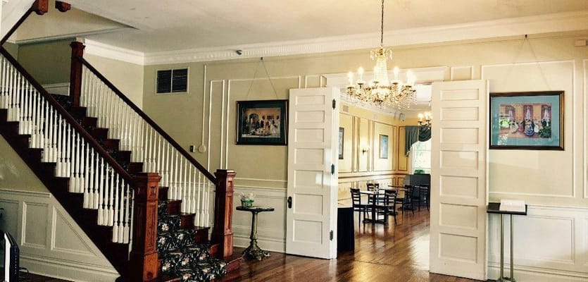 Interior view of a common area with staircase and chandelier