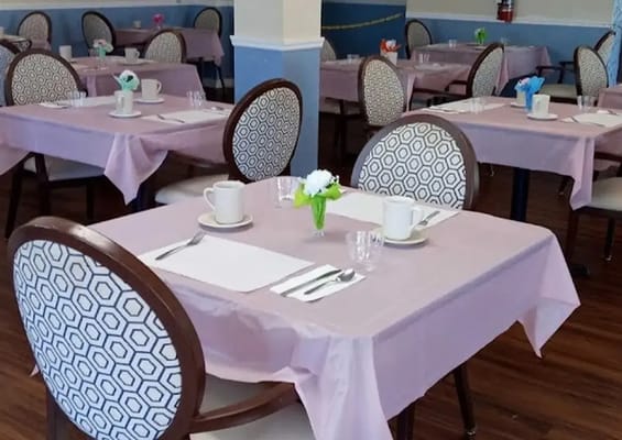 Dining area set up with tables and chairs