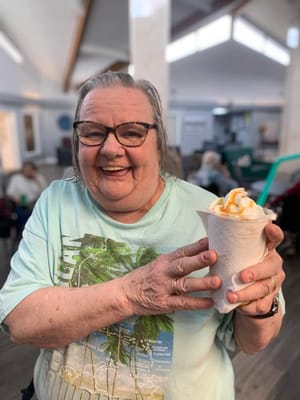 Resident enjoying a dessert in a common area