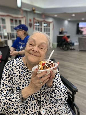 Resident enjoying a dessert in a common area