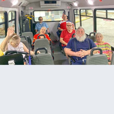 Residents enjoying a ride on a facility shuttle bus