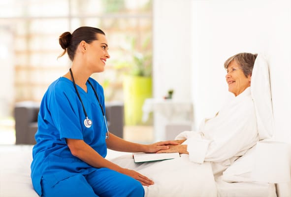 Nurse interacting with a senior resident in a bright room