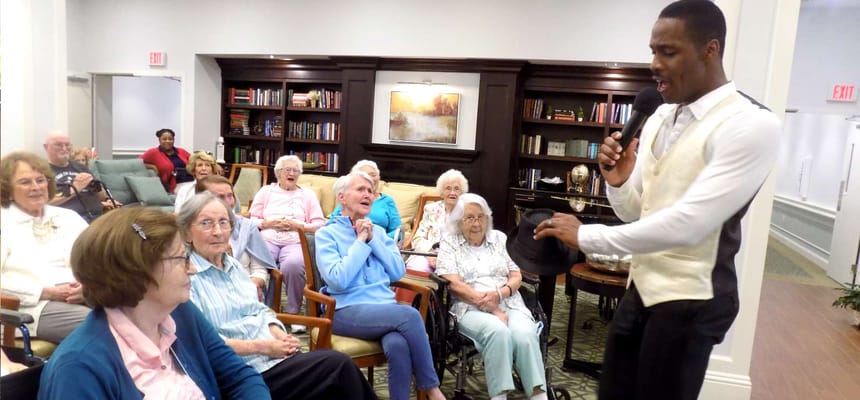 Residents enjoying a performance in a common area