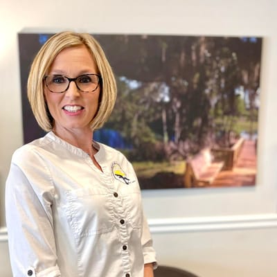 Smiling staff member in a well-lit facility interior