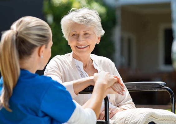 A caregiver and resident sharing a warm moment outdoors