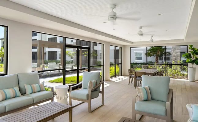 Bright common area with comfortable seating and views of outdoor space