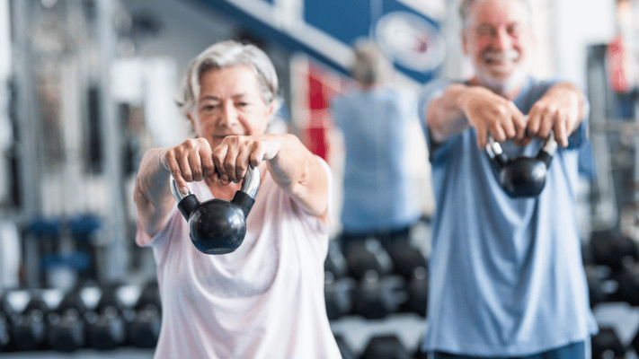 Seniors exercising with kettlebells in a gym