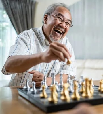 Senior man enjoying a chess game in a bright room