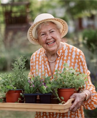 Resident gardening outdoors with potted plants