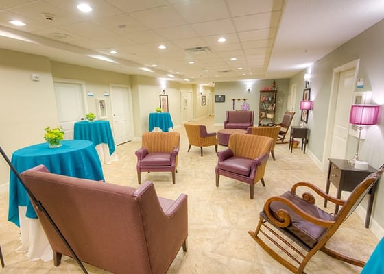 Common area seating with tables in a bright lobby