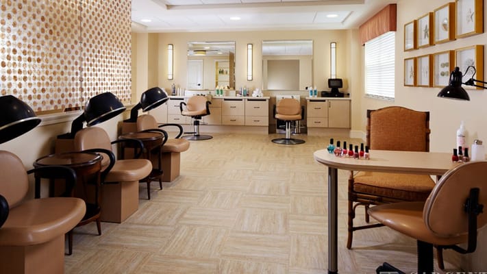 Beauty salon interior with styling stations and nail polish