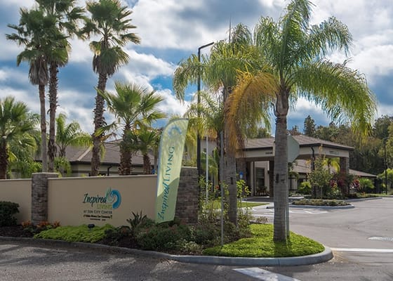 Entrance to Inspired Living at Sun City Center with landscaping