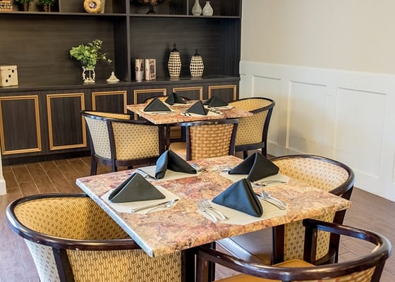 Dining area with neatly set tables and decor