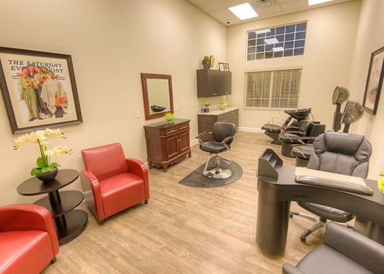 Well-lit hair salon interior with stylist chairs