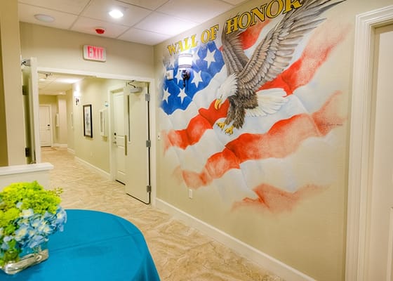 Interior hallway with a patriotic mural and blue table
