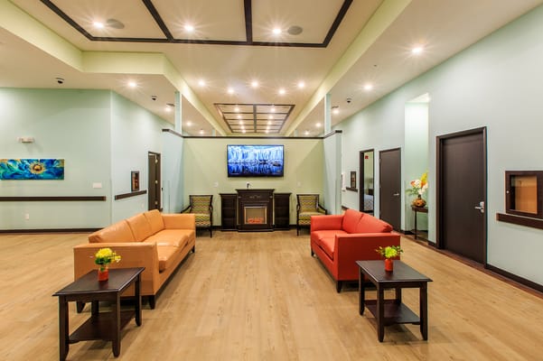 Bright common area with seating and a TV