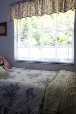 Cozy bedroom with a window and floral bedding