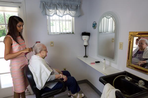 Resident getting a haircut in a salon.