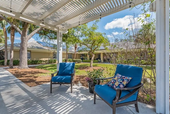 Outdoor seating area with blue chairs in a garden