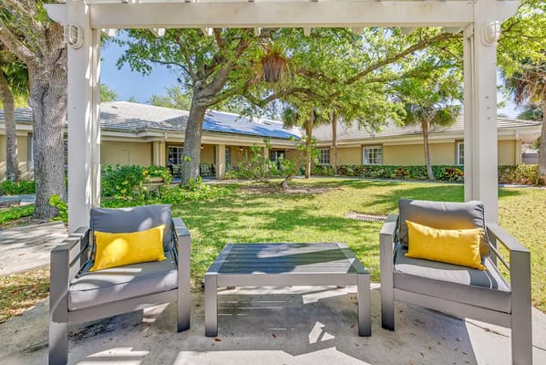 Seating area under a pergola in a garden