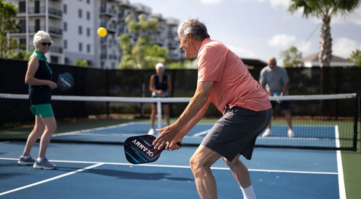 Residents playing pickleball on an outdoor court