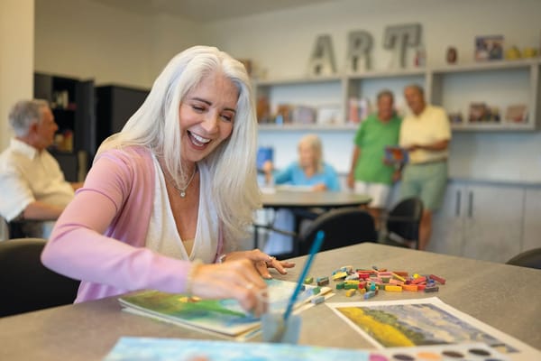 Residents engaged in an art activity in a common area