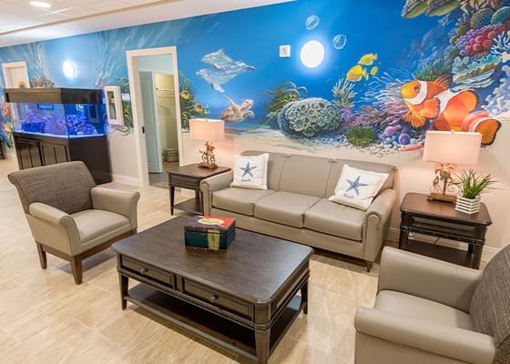 Bright interior common area with seating and colorful mural